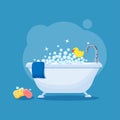 Bathtub full of soap foam bubbles with  blue towel, rubber yellow duck, sponge and bar of soap Royalty Free Stock Photo